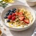 Greek-style yogurt breakfast bowl with berries, banana, walnuts and pistachios